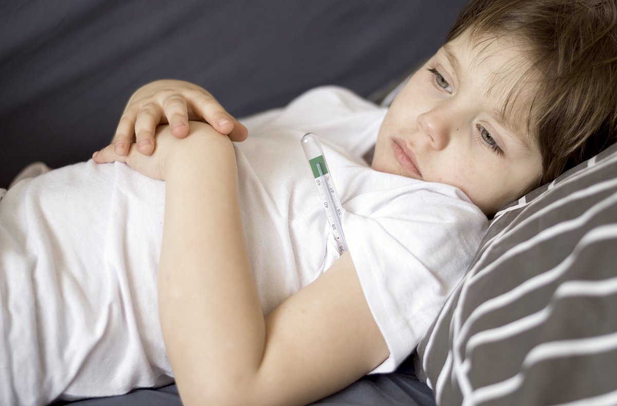 front-view-sick-child-sitting-bed.jpg